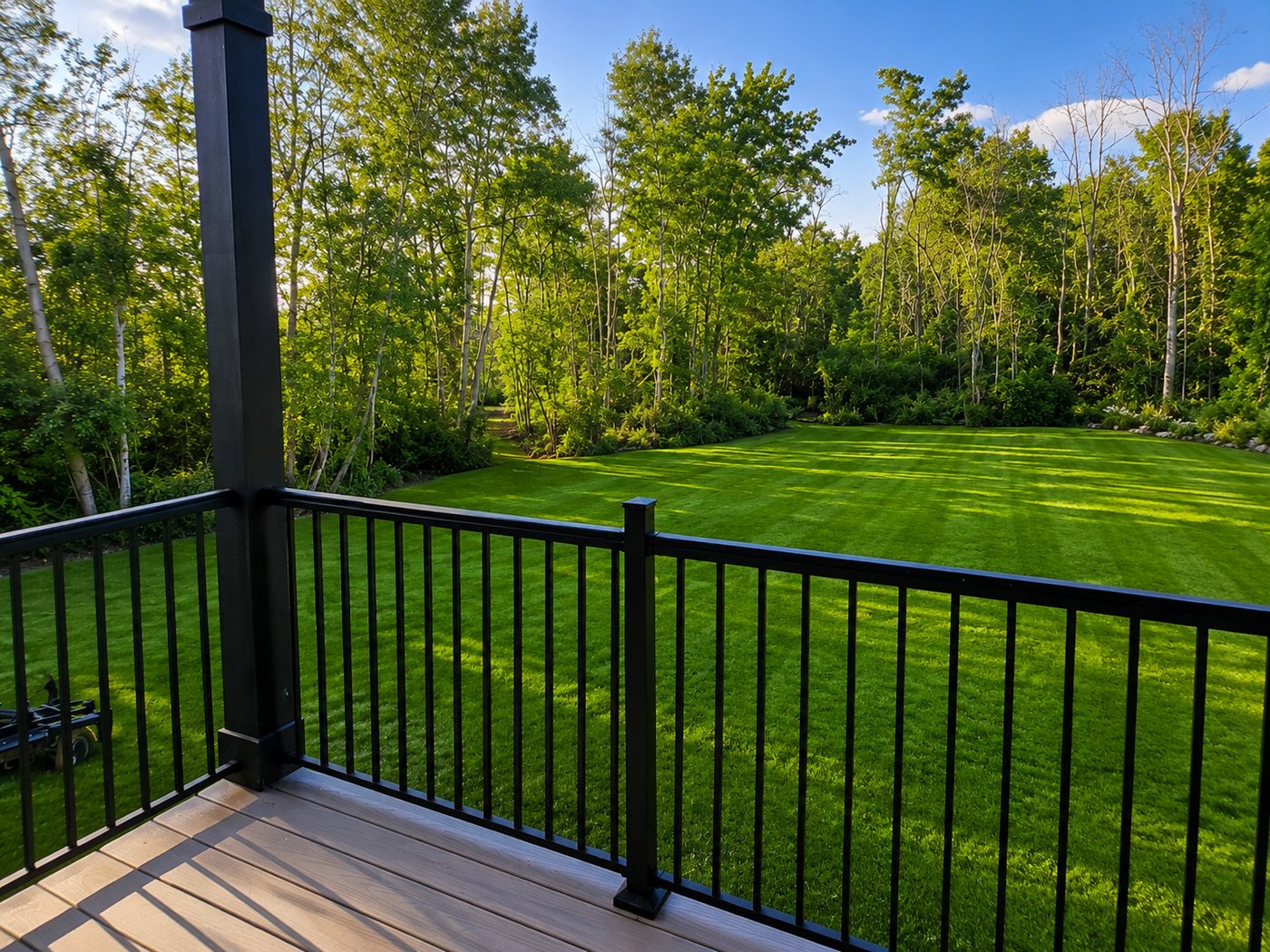 Private walk-out patio overlooking the lawn and woods